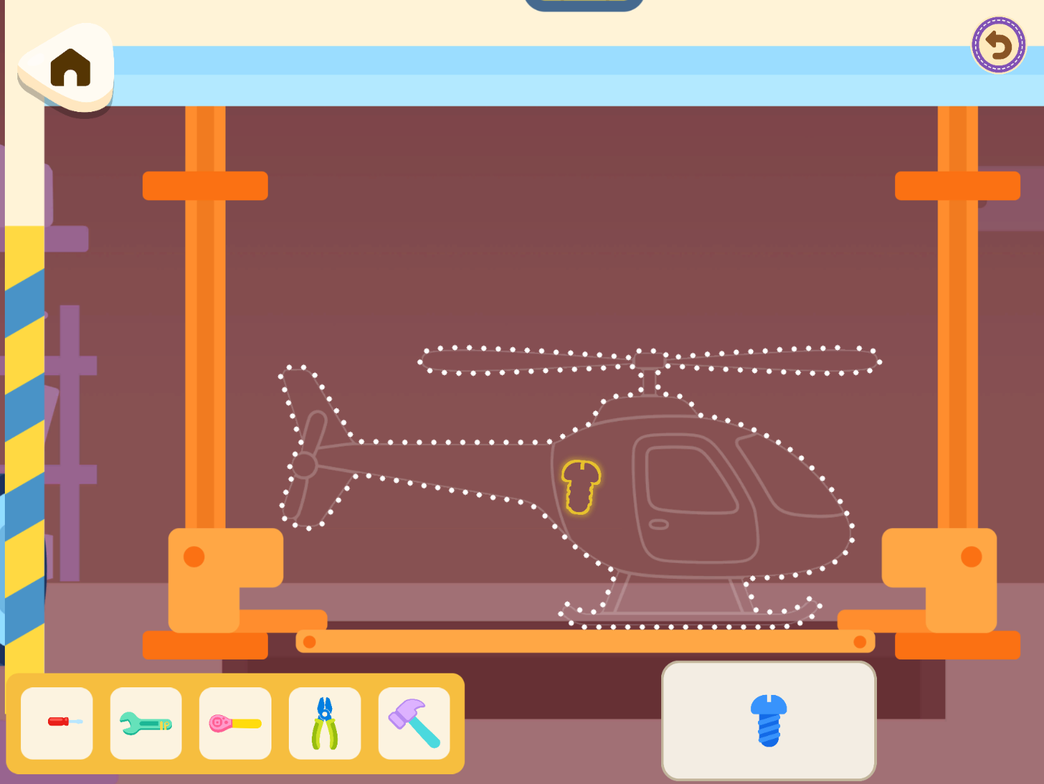 Vroom's workshop, with a dotted helicopter outline and a tray of tools